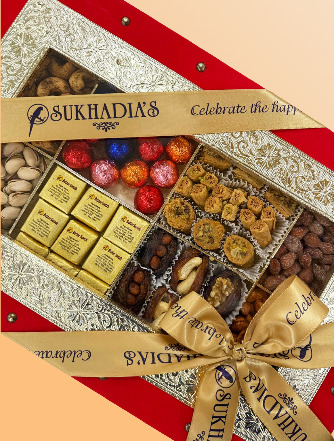 Sukhadia's assorted dry fruits and sweets gift box with a decorative ribbon.