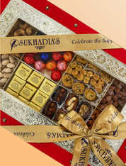 Sukhadia's assorted dry fruits and sweets gift box with a decorative ribbon.